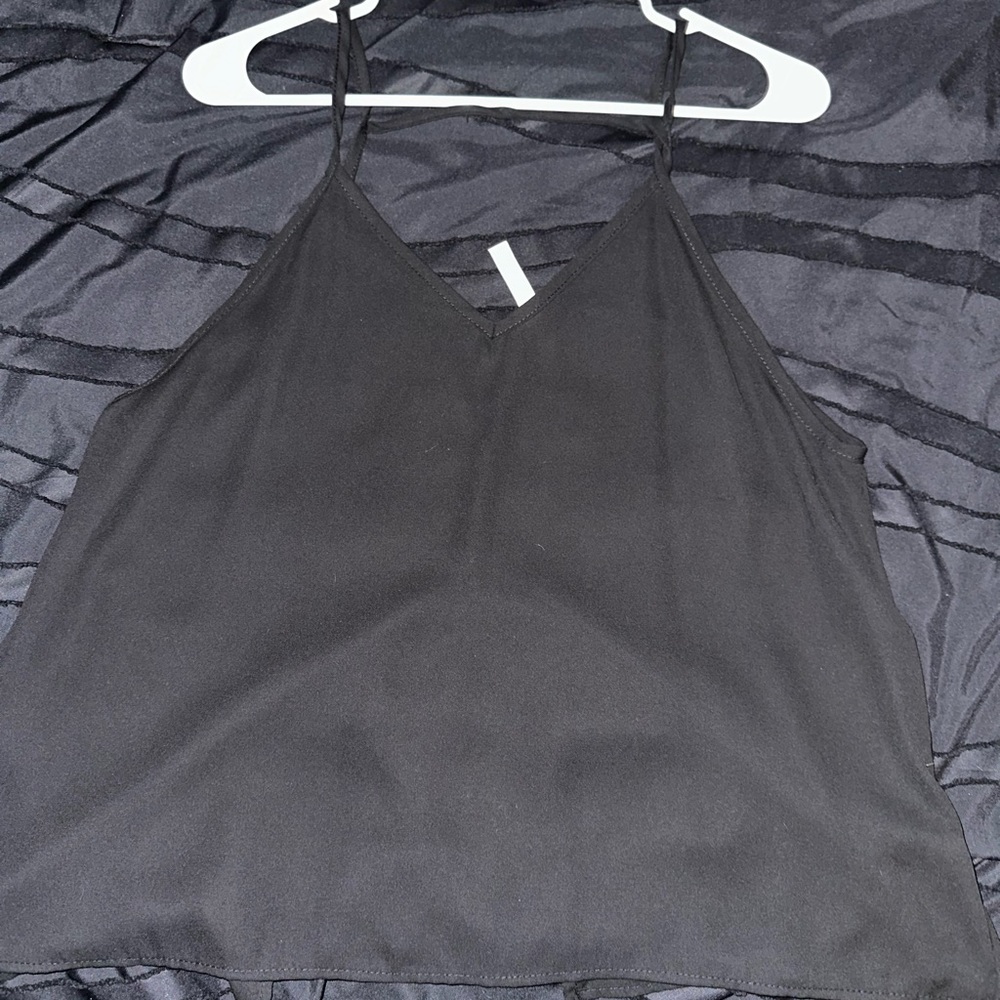It is a black tank top-ish shirt in a size large.